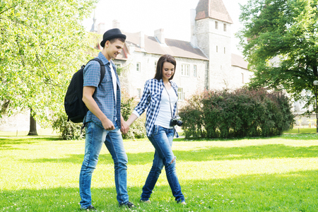 Attractive couple having an enjoyable walk in the summer garden.の写真素材