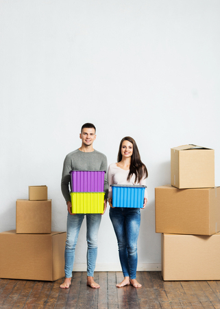Young couple moving in a new home. Man and woman with boxes.の写真素材