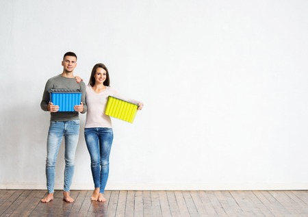 Young couple moving in a new home. Man and woman with boxes.の写真素材