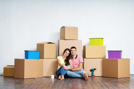 Young couple moving in a new home. Man and woman with tools and boxes.の写真素材