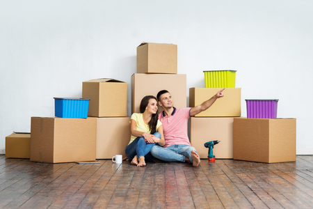 Young couple moving in a new home. Man and woman with tools and boxes.の写真素材