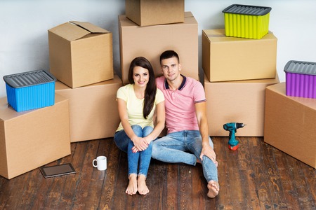 Young couple moving in a new home. Man and woman with tools and boxes.の写真素材