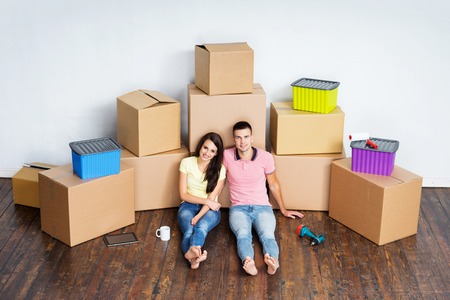 Young couple moving in a new home. Man and woman with tools and boxes.の写真素材