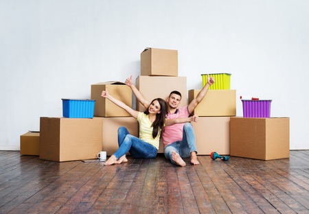 Young couple moving in a new home. Man and woman with tools and boxes.の写真素材