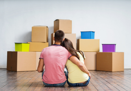 Young couple moving in a new home. Man and woman with boxes.の写真素材