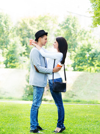 Young beautiful couple full length in the park.の写真素材