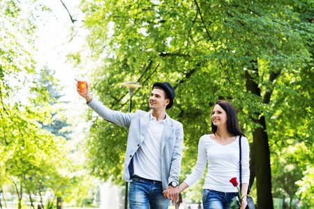 Young beautiful couple having a date in the park.の写真素材