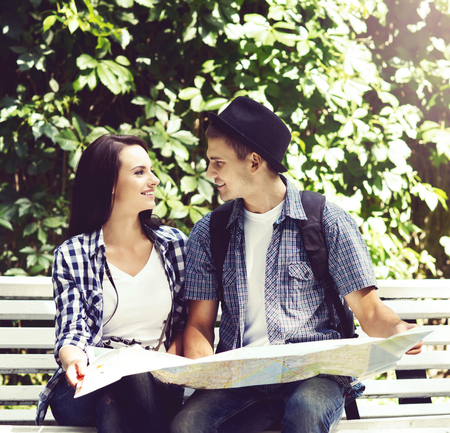 Young travelling couple: checking the map. Holiday, vacation, summer: concept.の写真素材