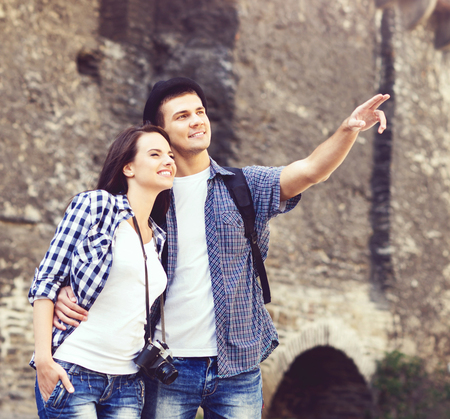 Couple of young travellers: walking around old town. Vacation, summer, holiday, tourism: concept.の写真素材