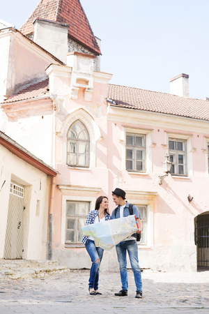 Young tourists trying to find their next destination in the map.の写真素材