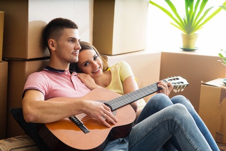Young couple moving in a new home. Man and woman with boxes.の写真素材