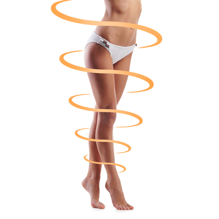 Close-up of thin and beautiful female body. Weight loss, sports, exercising, tan, sun burn concept.の写真素材
