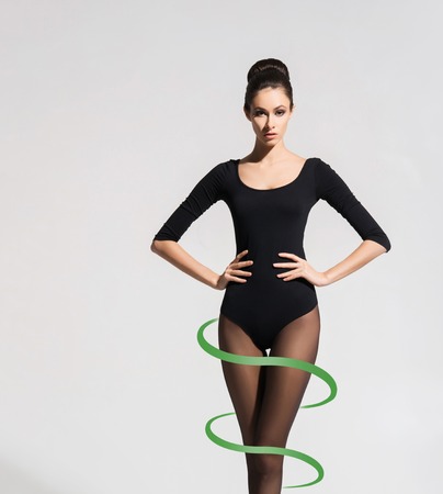 Young, sporty and seductive woman in tights. Weight loss, healthy eating, perfect body, slim shape, nutrition, fitness, sport and diet concept.の写真素材