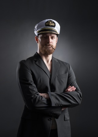 Portrait of a handsome sailor over black background.  Shipping, navigation, marine, navy concept.の写真素材
