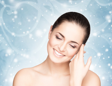 Spa portrait of young and beautiful woman over Christmas background. Face lifting and plastic surgery winter concept.の写真素材