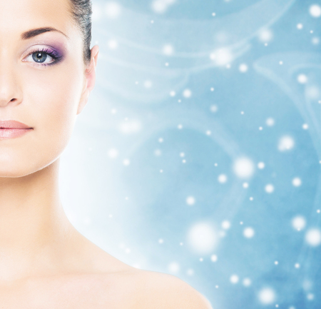 Spa portrait of young and beautiful woman over Christmas background. Face lifting and plastic surgery winter concept.の写真素材