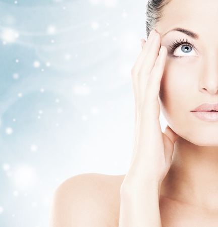Spa portrait of young and beautiful woman over Christmas background. Face lifting and plastic surgery winter concept.の写真素材