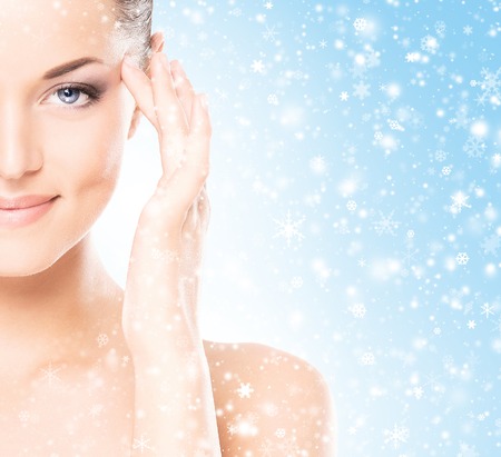 Spa portrait of young and beautiful woman over Christmas background. Face lifting and plastic surgery winter concept.の写真素材