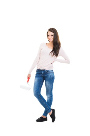 Young girl moving in a new home. Woman with tools isolated on white.の写真素材
