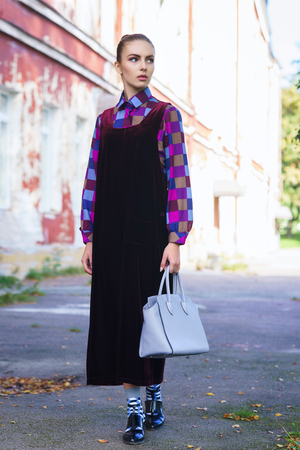 Beautiful and pretty young girl; standing in front of old house. Fashion, beauty, retro, streetlook: concept.の写真素材