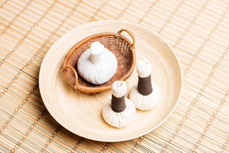 Massage bundles on a plate on bamboo mat. Spa, health, treatment, concept.の写真素材