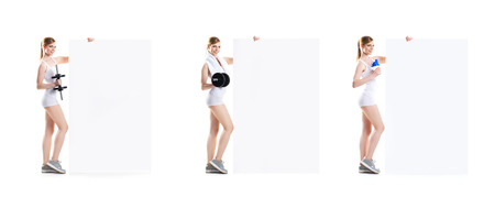 Beautiful hot young sporty woman with dumbbell standing nearby the billboard. Set collection.の写真素材
