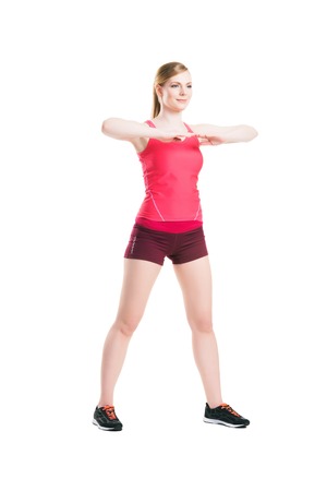 Fit, healthy and sporty woman in sportswear making physical exercises isolated on white.の写真素材
