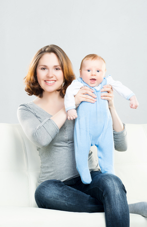 Young mother and her baby child. Infant son and his mum.の写真素材