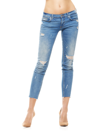 Slim and sexy female legs in jeans isolated on white.の写真素材