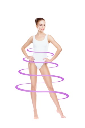 Close-up of thin and beautiful female body. Weight loss, sports, exercising, water balance, healthy nutrition concept.の写真素材