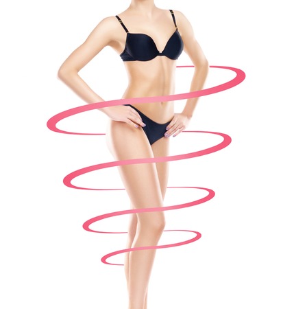 Fit and slender woman in swimsuit. Perfect female shape. Medicine, weight loss, fat burn and healthcare concept.の写真素材