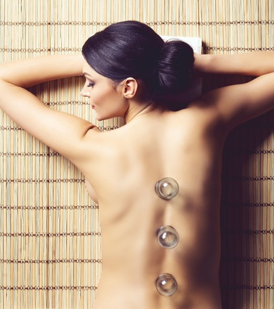 Healthy and beautiful woman getting massage treatment in spa salon.の写真素材