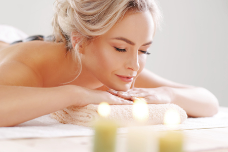 Young, beautiful and healthy woman relaxing in spa salon. Rejuvenation therapy and massaging treatments. Recreation concept.の写真素材