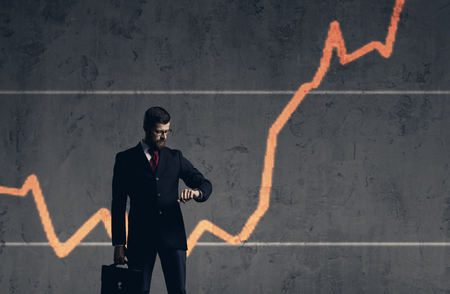 Businessman with briefcase standing  over diagram background. Business, office, success, concept.の写真素材