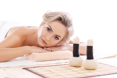 Young, beautiful and healthy woman relaxing in spa salon. Rejuvenation therapy and massaging treatments. Recreation concept.の写真素材