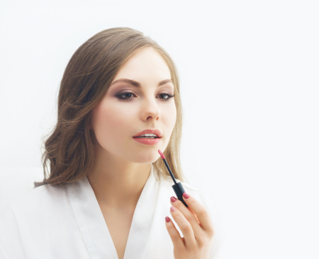 Beauty portrait of young and attractive woman with makeup brush.の写真素材