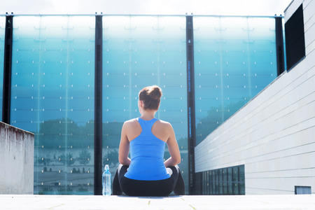 Young, fit and sporty woman resting after the training. Fitness, sport, urban jogging, healthy lifestyle concept.の写真素材