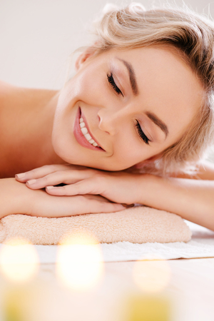 Young, beautiful and healthy girl relaxing in spa salon. Rejuvenation therapy and massaging treatments. Recreation concept.の写真素材
