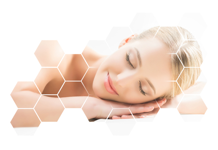 Beautiful and healthy blond woman getting massage treatment in spa salon.の写真素材