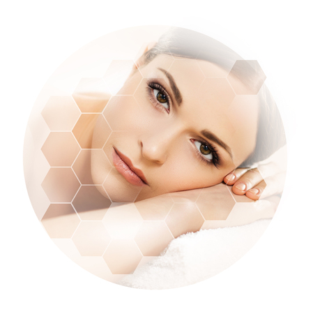 Young and beautiful woman in spa. Collage with honeycomb mosaic tiles. Massaging and healing concept.の写真素材