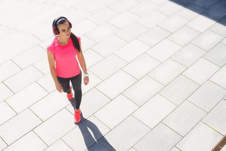 Young, fit and sporty woman running up the stairs. Fitness, sport, urban jogging and healthy lifestyle concept.の写真素材