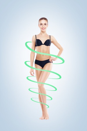 Fit, healthy and slim woman with a sporty body and a perfect shape isolated on white.の写真素材