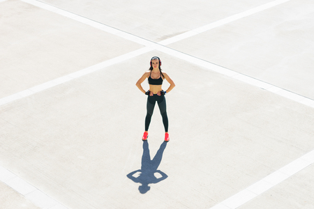 Young, fit and sporty girl stretching. Fitness, sport, urban jogging and healthy lifestyle concept.の写真素材