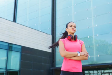 Young, fit and sporty girl in the street. Fitness, sport, urban jogging and healthy lifestyle concept.の写真素材