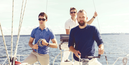 People traveling a yacht and enjoying a day. Summer, holiday, vacation concept.の写真素材