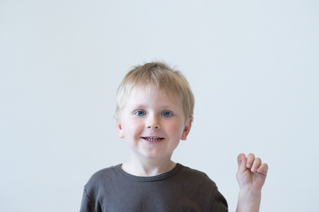 Studio portrait of a cute smiling boy. Happy child.の写真素材