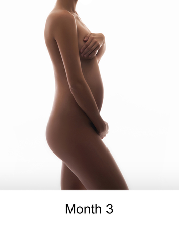 Naked pregnant woman isolated on whiteの写真素材