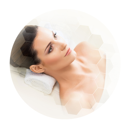 Young and beautiful woman in spa. Collage with honeycomb tiles. Healing and massaging concept.の写真素材