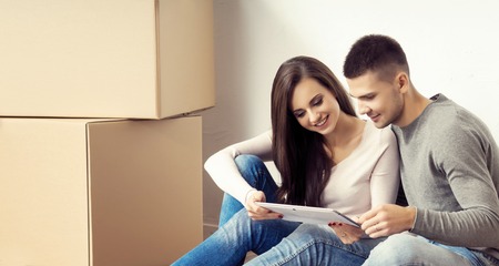 Young loving couple moving to a new house. Home and family concept.の写真素材
