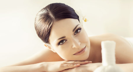 Portrait of a girl in spa. Massaging therapy procedure. Skin care and massage concept.の写真素材